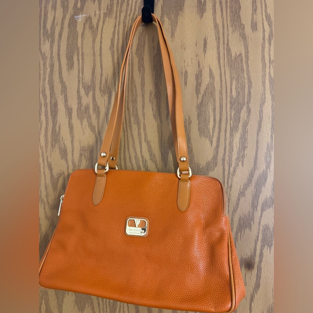 Valentina Purse 2 Handles Color: Orange Pebbled Leather. Feet on the Bottom.